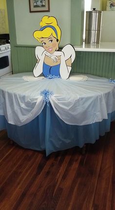 there is a table with an image of snow white on it and blue ribbon around the table