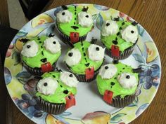 cupcakes with green frosting and white icing on a plate