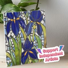 a stained glass panel with blue flowers on it and the words support independent artists below