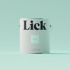 a white paint can with the word lick painted on it's side, in front of a green background