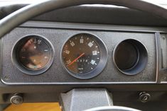 three gauges on the dashboard of a car