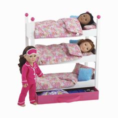 two dolls are standing next to each other on a bunk bed with pink sheets and pillows