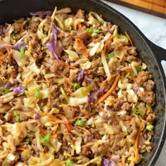 a skillet filled with ground beef and vegetables