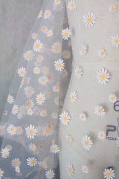 "Arriving next week. Back in stock by demand. Orders yours before it's gone. Need a cute, lightweight & sheer fabric for your special occasion? This printed daisies on off white tulle is perfect for the bride to be, flower girl or even just as window shades! Make hair ties and head bands with this daisy flower tulle. It is 63\" wide so 1 yard would be plenty for hair accessories. How about some pretty socks to go with your wedding guest attire? Use your creativity and I'm sure you'll find a spec Daisy Flower Painting On Fabric, Flower Printing On Fabric, Duppata Designer Lace, Fabric Paint Designs Creative, Fabric Painting Ideas, Floral Fabric Prints, Colorful Dupatta, Flower Print Fabric