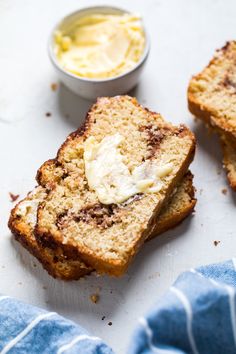 two slices of bread with butter on top and one slice cut in half next to it