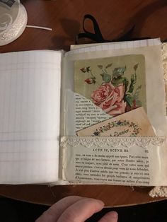 an open book sitting on top of a wooden table