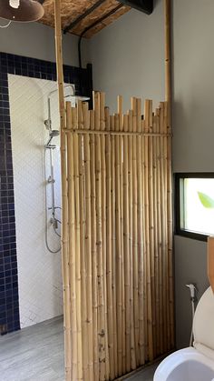 a bathroom with a bamboo shower and toilet