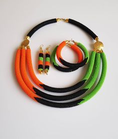 100% handcrafted using original fine beads. *Comes with matching earrings and 2 bracelets. The necklace is 18 inches long( round the neck). Each section is attached to one another nicely. S hook clasp is used for closure. **Buy multiple items and pay shipping for 1 item only.The rest ships free. More neckleces here; https://www.etsy.com/shop/TribalTess?ref=seller-platform-mcnav&section_id=21306083 Back to my shop; https://www.etsy.com/shop/TribalTess?ref=seller-platform-mcnav Traditional Orange Jewelry With Black Beads, Orange Beaded Earrings With Black Beads, Black Beaded Necklace With Colorful Beads, African Beadwork, African Beaded Necklace, African Inspired Jewelry, Spiral Jewelry, African Beads Necklace, Beaded Stuff