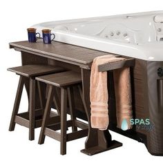 a large hot tub with stools and towels on the table next to each other