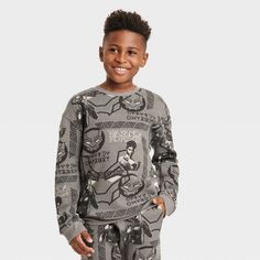 Your young warrior will be ready for cooler weather in this Marvel Black Panther Crewneck Fleece Sweatshirt. Made from a soft fleece fabric for cozy comfort, this crewneck sweatshirt is designed with banded cuffs and a banded hem for a snug fit, while flat seams offer them extra comfort. Adorned with allover print of the Black Panther face mask and Shuri with classic Wakandan art, they'll love coordinating it with a variety of their bottoms for versatile outfit options. Casual Fleece Sweatshirt With Character Print, Sporty Winter Sweatshirt With Character Print, Sporty Long Sleeve Sweatshirt With Character Print, Cotton Sweatshirt With Character Print For Loungewear, Character Print Cotton Sweatshirt For Loungewear, Cotton Character Print Sweatshirt For Loungewear, Fall Fleece Sweatshirt With Character Print, Casual Character Print Sweatshirt For Loungewear, Fleece Crew Neck Sweatshirt With Character Print