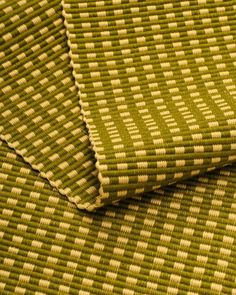 two pieces of green and white woven material