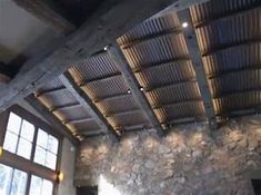 a stone wall and ceiling in a room