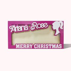 a pink wooden frame with the words merry christmas on it and a silhouette of a woman's head