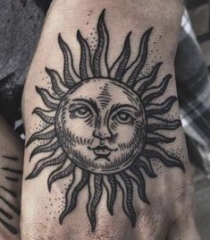 a hand with a sun tattoo on it