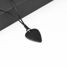 Pick-shaped necklace essential for musicians and music lovers. Developed with the best materials for your comfort! Excellent gift. Perfect gift for Musicians, Guitarists, Singers! Easy adjustment between 19 inches and 27 inches Material: Hypoallergenic 1.5mm black Waxed Cotton Leather Cord | Zamac metal and stainless steel pendant Black Minimalist, Music Headphones, Necklace Cord, Gothic Necklace, Treble Clef, Black Headphones, Music Gifts, Stainless Steel Pendant, Minimalist Necklace