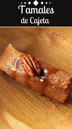 a piece of food that is on top of a wooden table with the words tamales de cajeta