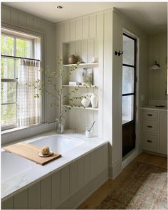 a white bath tub sitting next to a window