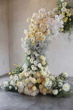 A beautifully decorated indoor wedding ceremony at the chapel of Stones of the yarra valley showcases an elegant floral display with white and yellow flowers, arranged in a graceful arch against a beige wall. A large stained glass window at the top lets in sunlight, while candles line the aisle, enhancing the luxury of this elevated design. Stage Flowers, Yarra Valley Wedding, Arch Designs, Photography Location, 2025 Wedding, Yarra Valley, Floral Inspiration, Valley Wedding, Sweetest Day