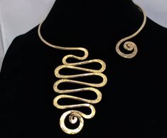 "This Open Collar Asymmetrical Necklace necklace is a Hand Hammered work of art. It will be the easiest necklace that you've ever put on in your life. Just slightly pull apart a few inches, slide it around your neck with a single hand and gently push it back to a comfy position. There are no clasps, no hooks, no connections. Be the envy, the talk of the town and stand out with this unique one of a kind body art. This is guaranteed comfort and be sure to get ready for lots of compliments. This is Unique Freeform Gold Necklace, Modern Jewelry With Unique Spiral Design, Elegant Spiral Jewelry With Unique Design, Unique Gold Swirl Jewelry, Unique Swirl Shaped Gold Jewelry, Unique Swirl-shaped Gold Jewelry, Adjustable Spiral Gold Necklace, Adjustable Gold Spiral Necklace, Elegant Spiral Necklaces For Jewelry Making