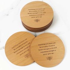 three wooden coasters with words on them sitting next to each other, one saying something you can never give up