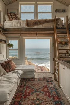 a living room with a couch and a rug on the floor next to a window