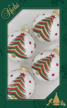 three white christmas ornaments with red, green and gold stripes