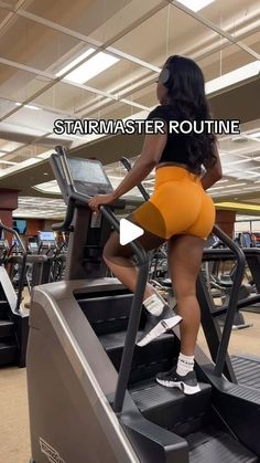 a woman is running on a treadmill