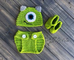 a crocheted hat, diaper and booties are on the floor