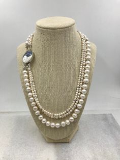 Wow..If you are looking for a statement necklace, here you go. This triple strand pearl necklace is made of luminous freshwater pearls ranging in size from petite 4mm to 5mm up to 9mm. Each strand of pearls also is highlighted by silver and cz spacers to add that little extra touch of shine. A glorious 28mm abalone box clasp set in silver finishes off the necklace. The clasp is so pretty I've pictured it on the side as opposed to the back as I wouldn't want to hide it if I was wearing it! This w Double Strand Pearl Beaded Necklace With Pendant, White Double Strand Pearl Necklace With Pearl Drop, Pearl White Double Strand Necklace With Pearl Drop, Double Strand Pearl White Necklace With Pearl Pendant, Double Strand Beaded Pearl Necklace, Double Strand Pearl White Necklace With Pearl Drop, White Double Strand Pearl Drop Necklace, White Double Strand Pearl Necklace With Pendant, Double Strand Pearl Pendant Necklace In White