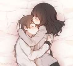 two people hugging each other on a bed