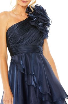 An exuberant rosette shoulder appliqué and gathered bodice create luxe dimension on a gorgeous gown fashioned with asymmetric ruffles at the high-low hem. 62 1/2" length (size 8) One-shoulder neck Sleeveless Partially lined 100% polyester Spot clean Imported Asian Owned/Founded Short Wedding Guest Dresses, Midnight Color, Midnight Blue Dress, High Low Gown, High Low Maxi Dress, Mac Duggal Dresses, Short Cocktail Dress, Spring Floral Dress, Ruched Bodice