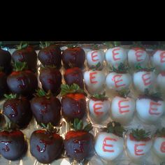 chocolate covered strawberries are arranged on display