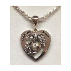 a marine mom heart necklace with an eagle and globe on the front, in silver