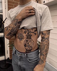 a person with tattoos on their stomach