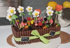 a cake decorated with strawberries, carrots and flowers