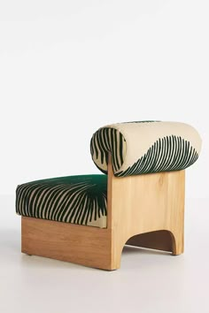 a zebra print chair with a green cushion