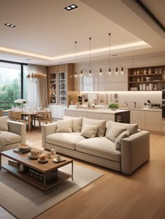 a living room filled with furniture next to a kitchen and dining room table on top of a hard wood floor