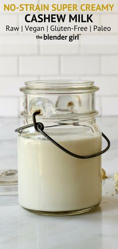 a glass jar filled with milk sitting on top of a counter