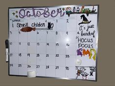 a calendar with writing on it is hanging on the wall