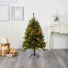 a small christmas tree in a room with presents