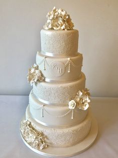 a three tiered wedding cake with white flowers