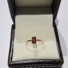 14k solid yellow gold natural emerald cut shaped garnet gemstone ring. 1. The weight of the natural garnet gemstone used in the ring =0.55 cts. 2. The weight of the 14k solid yellow gold used in the ring =0.880 grms. 3. The garnet is the birthstone for the people born in the month of January. 4. The design of the ring is very nice and beautiful. 5. I have used all my skills and experience to manufacture this ring as beautiful as I can and I do hope that my work will be appreciated. Thanks Yellow Gold Emerald Cut Ruby Ring Gift, Yellow Gold Garnet Rings For Gifts, Emerald Cut Hallmarked Ruby Ring In 14k Gold, Yellow Gold Baguette Cut Birthstone Ring Gift, 14k Yellow Gold Ruby Ring For Proposal, 14k Yellow Gold Birthstone Proposal Ring, 14k Yellow Gold Birthstone Ring For Proposal, 14k Gold Stackable Rings Baguette Cut For Gift, 14k Gold Stackable Baguette Cut Rings As Gifts