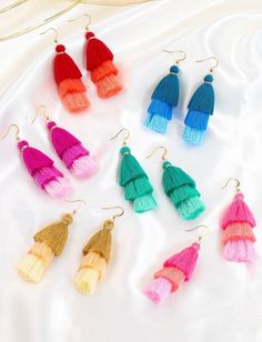 multicolored tassel earrings on white background