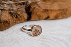 This ring features a beautiful warm earthy colored dendritic agate with plant like inclusions.   The ring is simple yet bold and also sturdy so you can wear it every day.  I chose a 14k gold bezel as it compliments the earthy color of this dendrite. I finished the ring in a mirror shine. Details: - this ring measures a US size 8.25 (18.25 mm), Due to the wide band it will best fit a US size to 8 (18 mm).  - the face of the ring measures about 15 mm (0.6 inch) x 13 mm (0.5 inch) - the ring band is about 4 mm wide and 2 mm thick - the material used is recycled sterling silver and recycled 14k solid gold The plant like inclusions, called dendrites, are made from traces of iron oxide and/or manganese and grow in the rock as it forms. Each stone is totally unique. Dendrite agates, with their sm Nature-inspired Sterling Silver Cabochon Ring, Everyday Nature-inspired Sterling Silver Rings, Nature-inspired Agate Rings With Natural Inclusions, Minimalist Everyday Jewelry With Natural Inclusions, Nature-inspired Ring With Natural Inclusions, Minimalist Jewelry With Natural Inclusions For Everyday, Minimalist Sterling Silver Rings With Natural Inclusions, Earthy Rings, Obsidian Ring