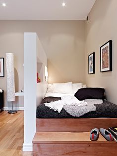 a bed sitting on top of a wooden floor