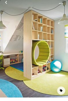 a child's room with a book shelf and play area