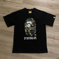 A Bathing Ape T-Shirt Only Worn A Couple Times Still Looks Brand New, Size L But Fits Like A Size M Camouflage Letter Print T-shirt For Streetwear, Camouflage Graphic Print Crew Neck T-shirt, Camouflage Graphic Print T-shirt For Streetwear, Relaxed Fit Camouflage T-shirt With Graphic Print, Camouflage Graphic Tee With Print, Camouflage Cotton T-shirt With Letter Print, Camouflage Crew Neck T-shirt With Graphic Print, Camouflage Crew Neck T-shirt With Letter Print, Camouflage Graphic Tee For Streetwear