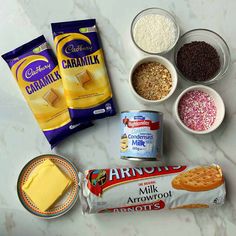 the ingredients to make an ice cream sandwich laid out on a marble counter top, including milk, sugar, and cookies