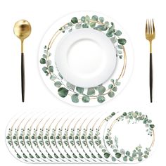 a set of dinnerware with green leaves and gold trimmings on the side