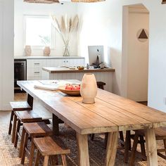 a wooden table sitting in the middle of a kitchen